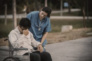 A nurse takes care of a patient at the hospital,Female doctor helping a patient in physical therapy